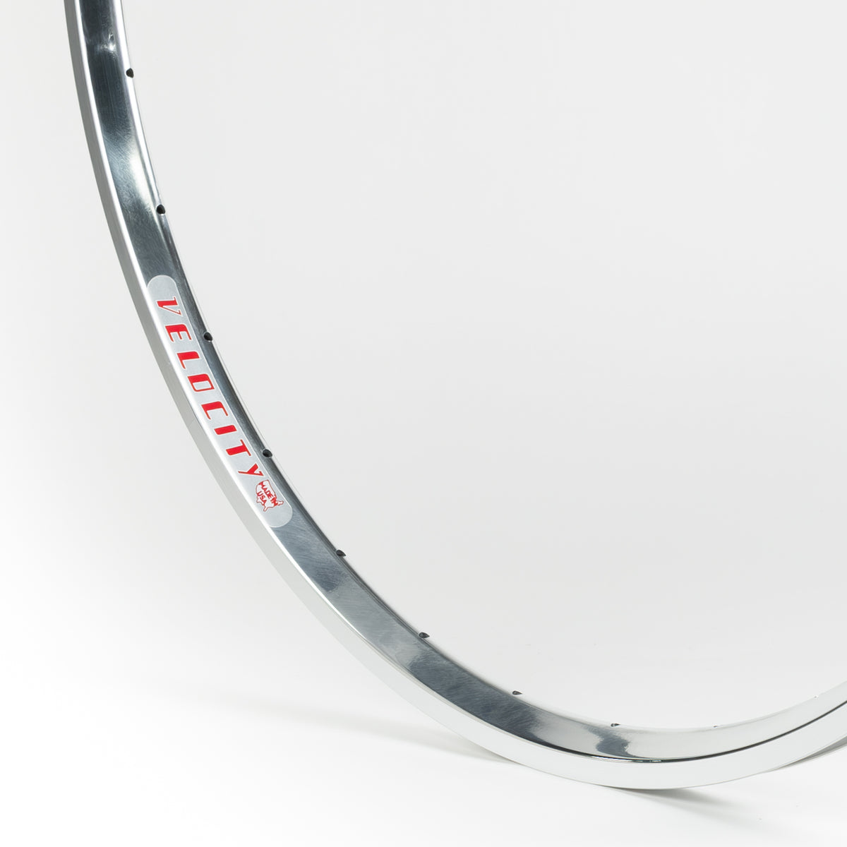 Velocity USA A23 OC Polished Machined Sidewall bicycle rim, close-up shot on a white background