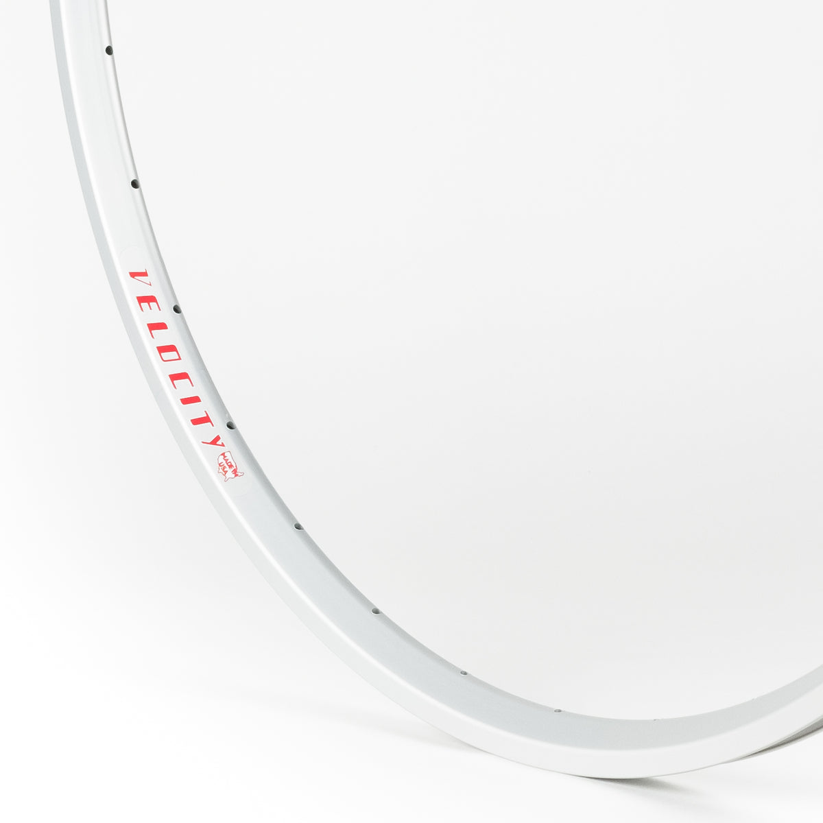 Velocity USA A23 OC Silver bicycle rim, close-up shot on a white background