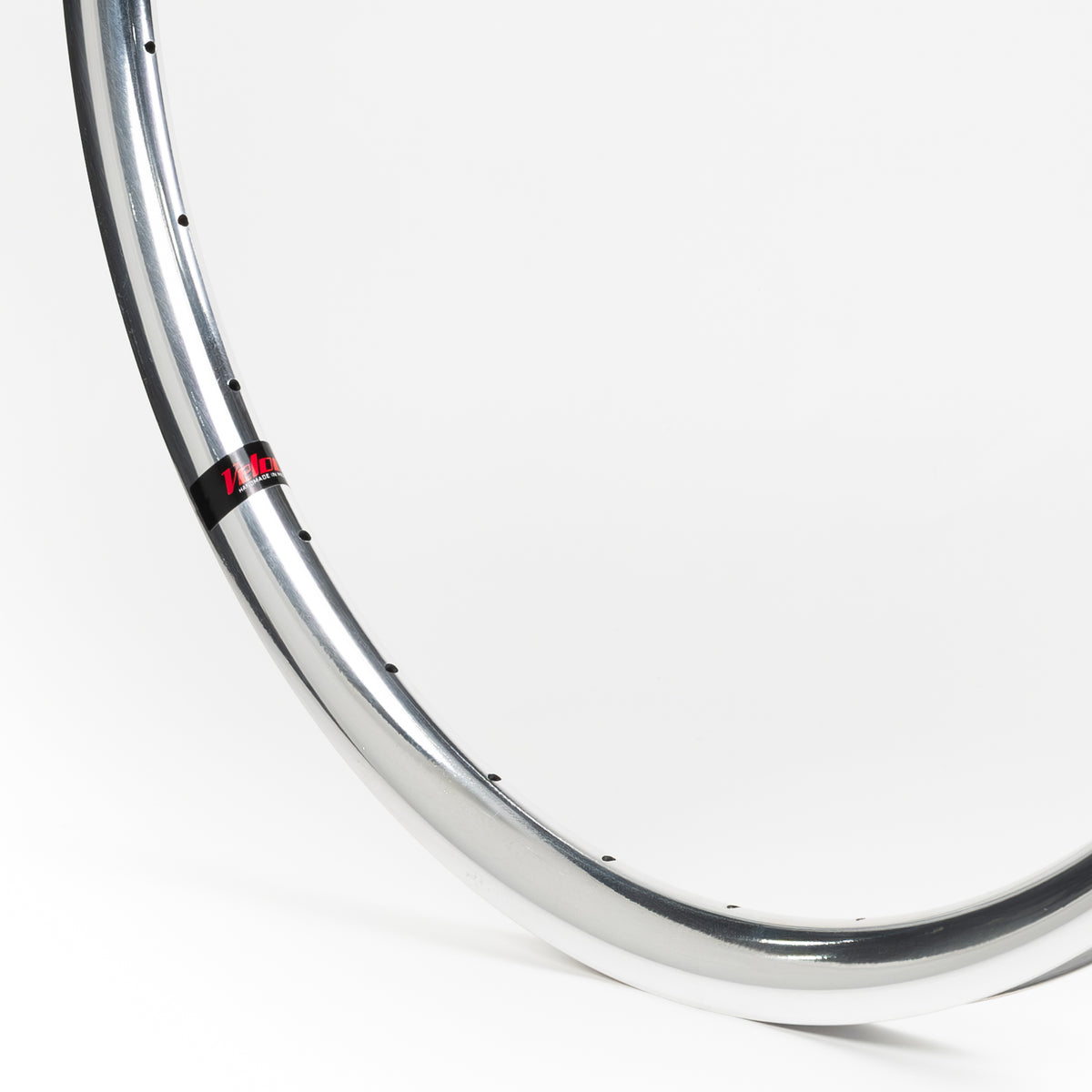Velocity USA Aero Polished bicycle rim, close-up shot on a white background