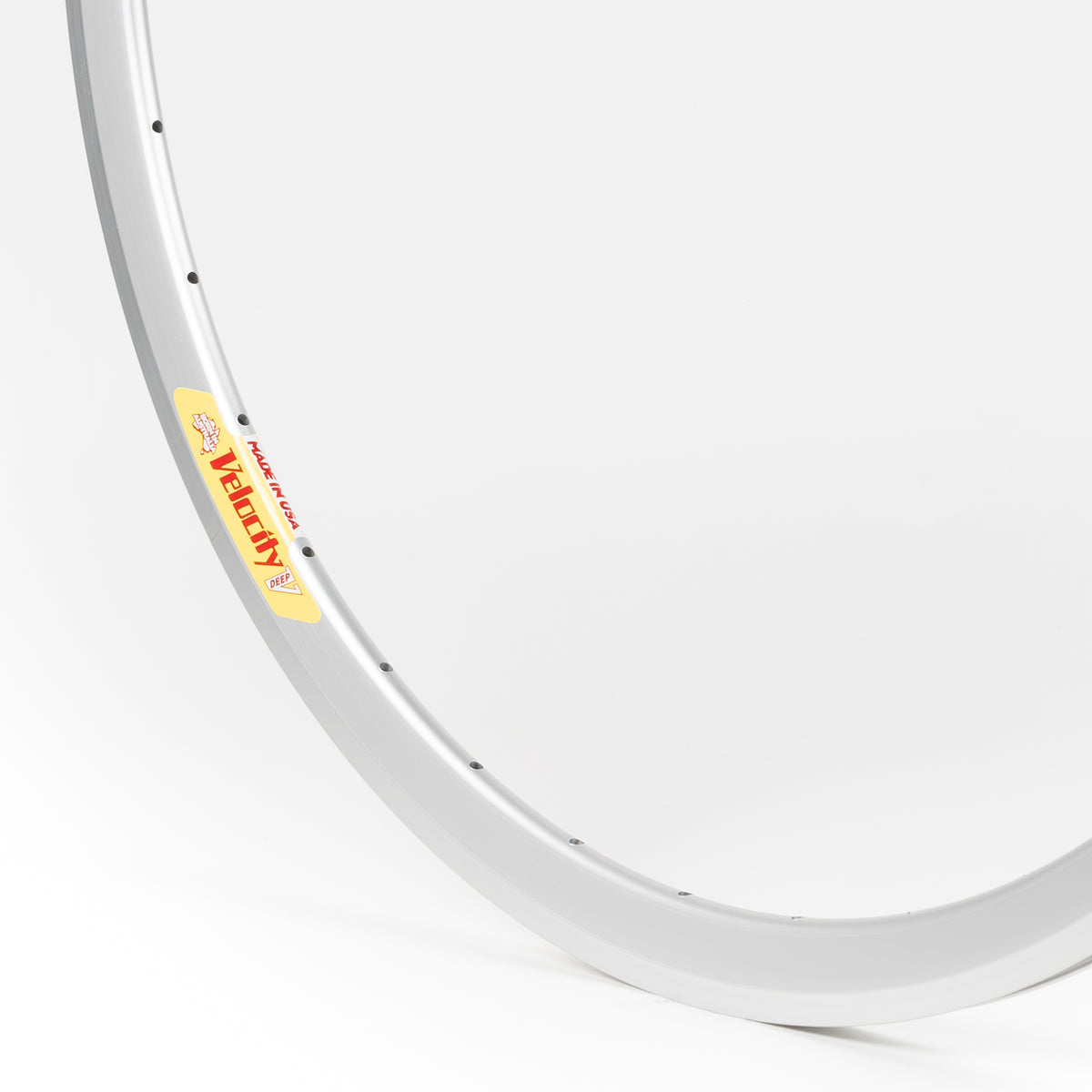 Velocity USA Deep V Silver bicycle rim, close-up shot on a white background