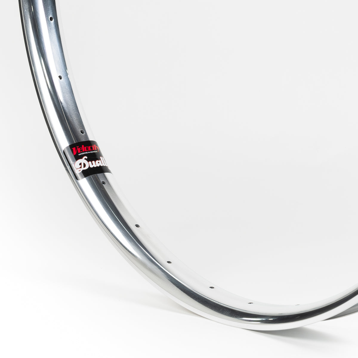 Velocity USA Dually Polished bicycle rim, close-up shot on a white background
