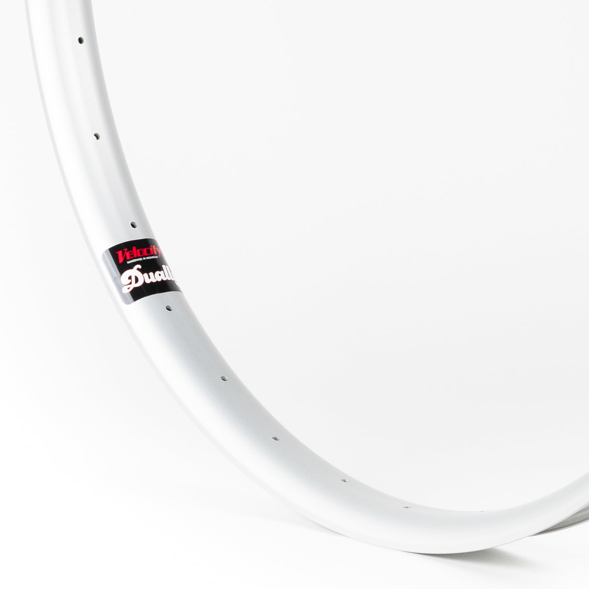 Velocity USA Dually Silver bicycle rim, close-up shot on a white background