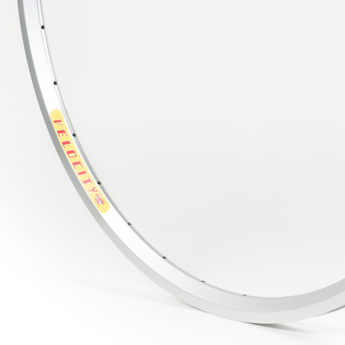 Velocity USA Dyad Silver bicycle rim, close-up shot on a white background